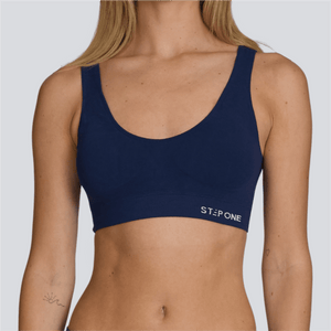 Navy blue sports bra with 'Step One' branding on a plain background  - Model:Emily