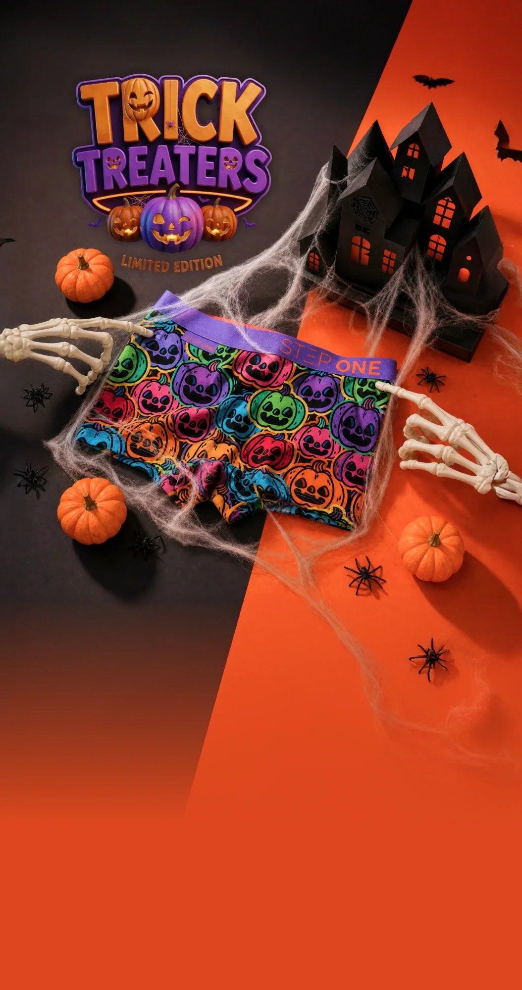 Trick Treaters limited edition: the kids pumpkin-print trunk caught in cobwebs between two skeleton hands, with mini pumpkins, spiders and a haunted house on black and orange